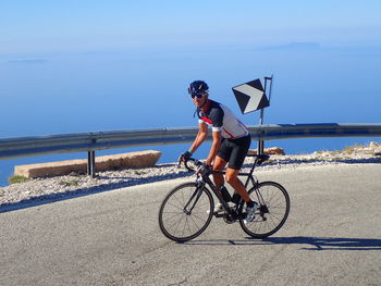 Man riding bicycle on road