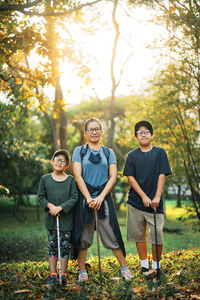 Full length portrait of mother and kids at park