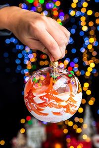 Midsection of person holding christmas decoration