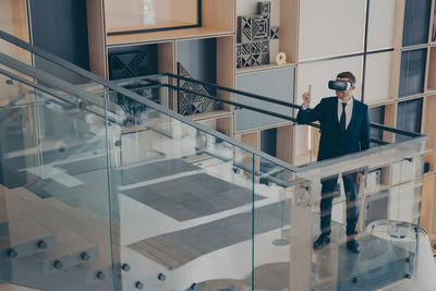 Man standing on staircase of building