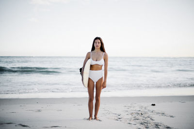 Full length of young woman on beach