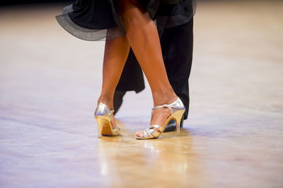 Low section of couple dancing on floor