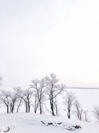 Scenic view of snow covered landscape against clear sky