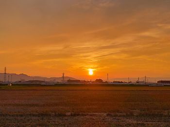 Scenic view of field against sky during sunset