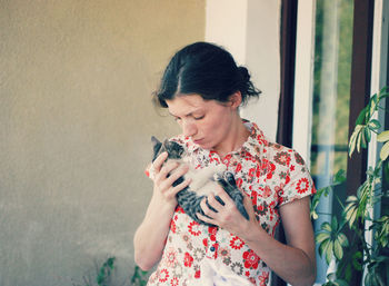 Young woman holding kitten