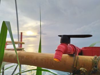 Low angle view of red railing against sky