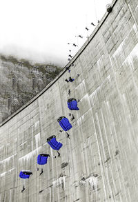 Clothes hanging on city against sky