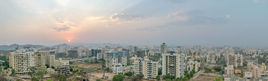 High angle view of buildings against sky during sunset