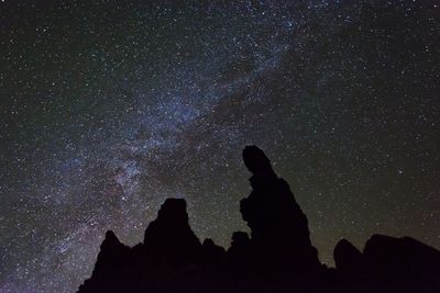 Low angle view of silhouette people against sky at night