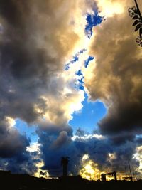 Low angle view of silhouette building against sky during sunset