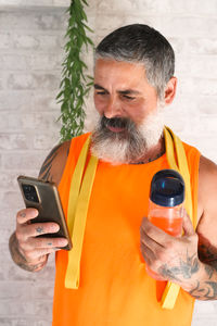 Side view of man drinking glass
