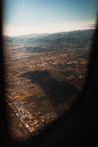 High angle view of cityscape against sky seen through window