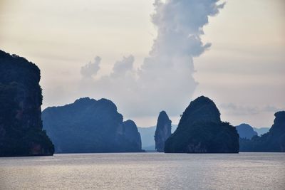 Rock formations in sea against sky