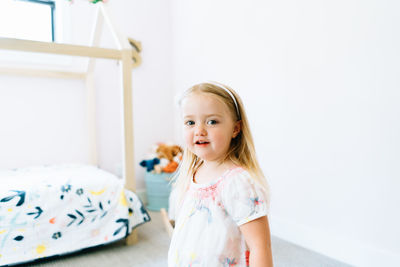 Closeup portrait of a young girl in her modern bedroom