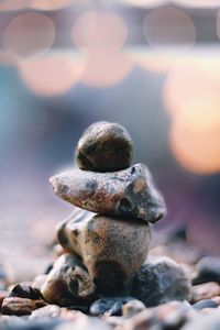 Close-up of stone stacked during sunny day