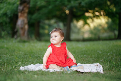 Cute girl sitting on field