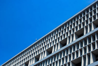 Low angle view of building against clear blue sky