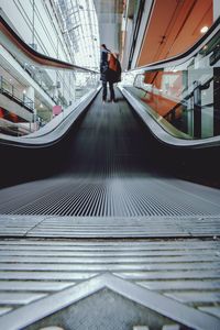 Rear view of woman walking in corridor