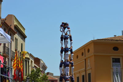 Low angle view of buildings against clear blue sky