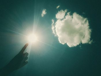 Low angle view of hand against sky