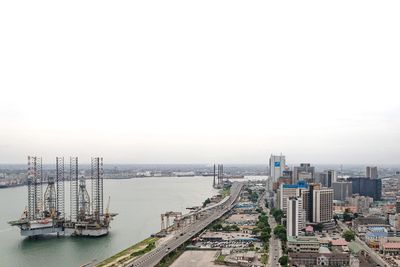 High angle view of buildings and city against sky