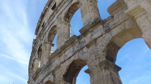 Low angle view of coliseum against sky