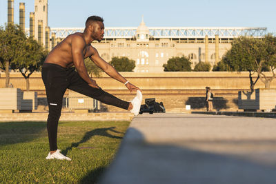 Side view of man looking at city