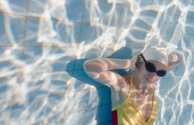 Portrait of young female model posing in pool