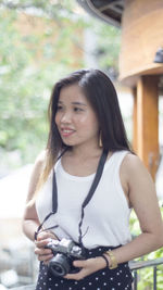 Portrait of a beautiful young woman standing outdoors