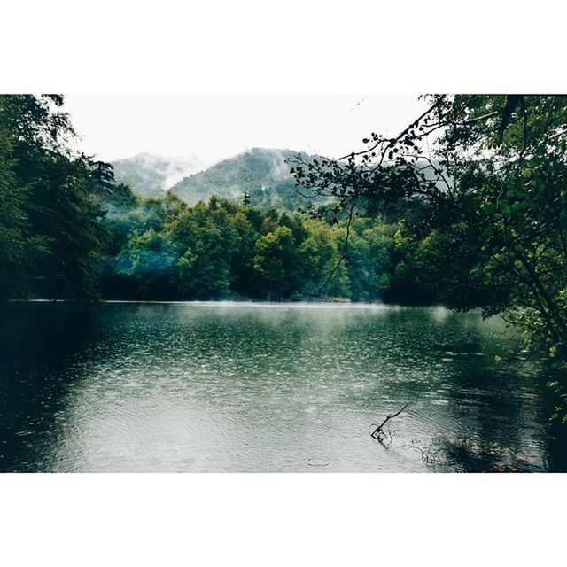 water, mountain, transfer print, tree, tranquil scene, scenics, tranquility, lake, beauty in nature, auto post production filter, nature, waterfront, mountain range, river, idyllic, sky, clear sky, reflection, day, growth