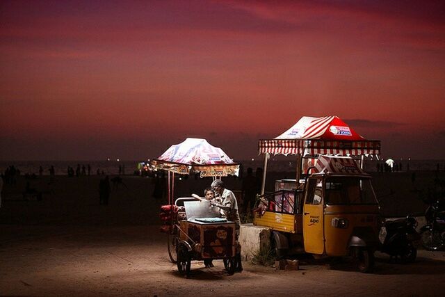 sea, chair, beach, sky, horizon over water, sunset, men, table, person, vacations, sand, lifestyles, absence, leisure activity, parasol, incidental people, seat, restaurant, water