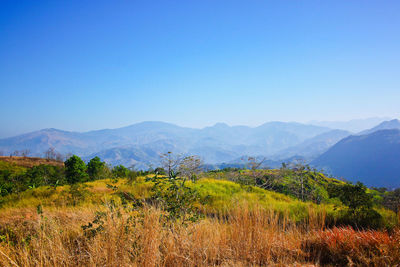 Scenic view of mountains against clear blue sky