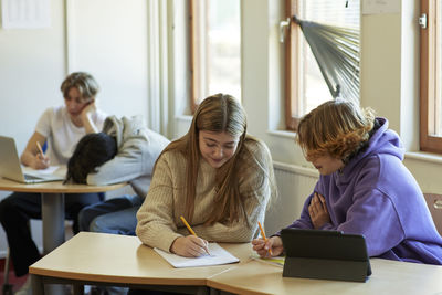 Group of students taking notes in class