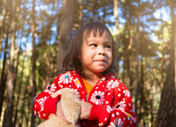 Portrait of cute girl in forest