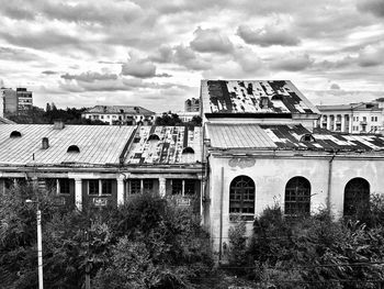 Exterior of city against cloudy sky