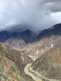 Scenic view of mountains against cloudy sky