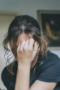 Close-up portrait of a woman covering face