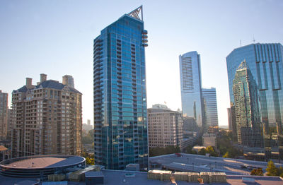 Modern buildings in city against clear sky