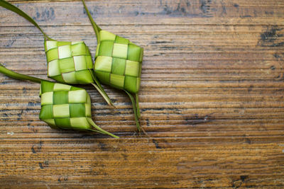 High angle view of green boxes on wooden table