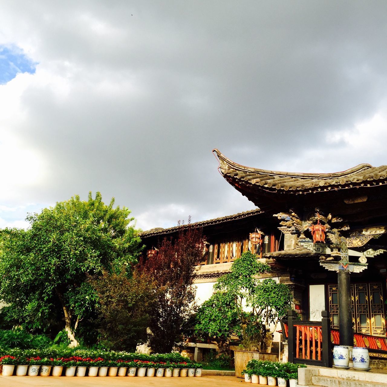 architecture, built structure, building exterior, sky, tree, place of worship, temple - building, cloud - sky, religion, spirituality, cloudy, roof, low angle view, famous place, travel destinations, cloud, tradition, cultures, history