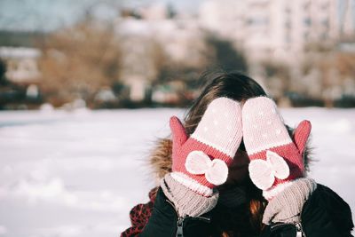 Close-up of woman covering her face