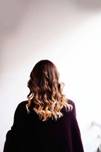 Rear view of woman against white background