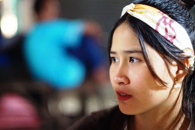 Close-up portrait of woman looking away