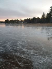 Scenic view of frozen lake against sky during winter