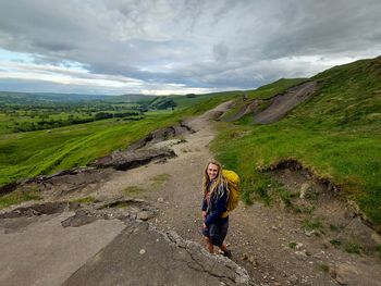 Full length of man standing on landscape against sky