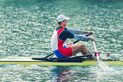 Side view of athlete rowing on sea