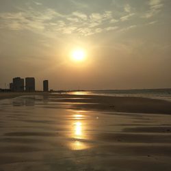 Scenic view of beach against sky during sunset