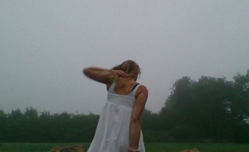 Woman standing on grassy field