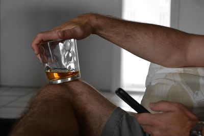 Midsection of man holding drink