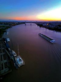 High angle view of illuminated city against sky at sunset